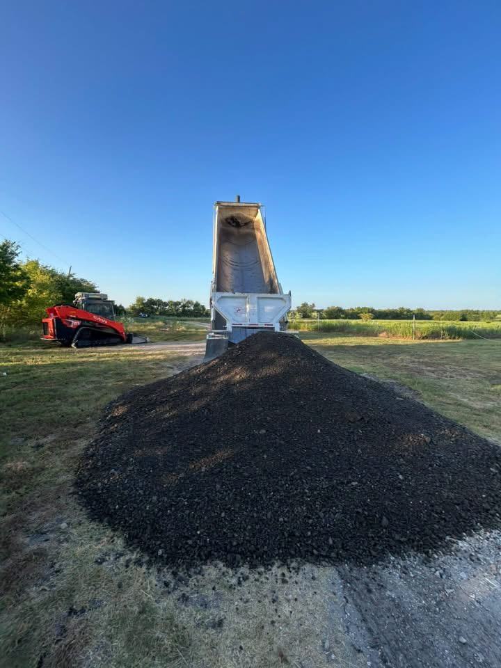 Dump truck delivering base material for a driveway project